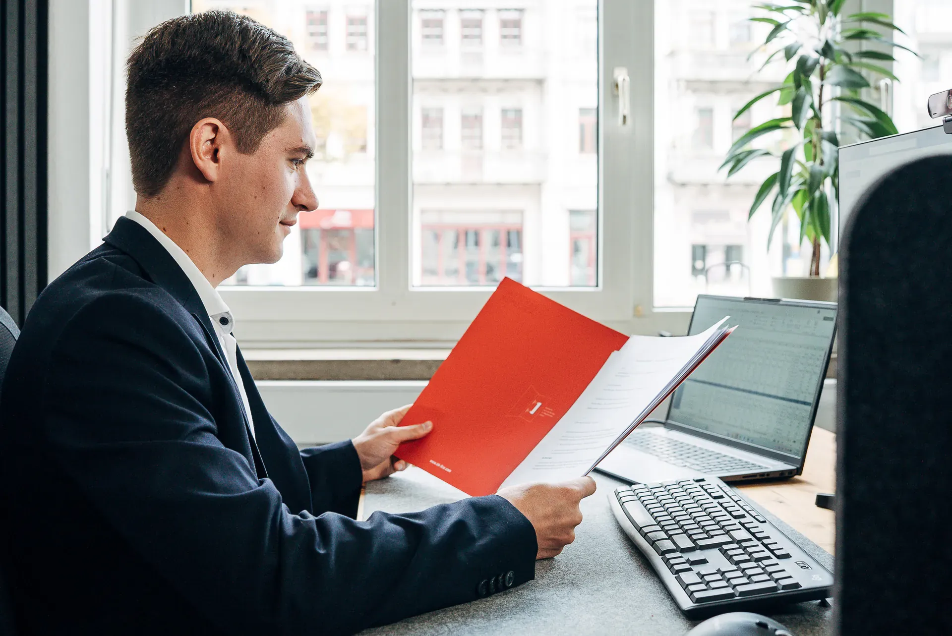 Berater von Blobel Consulting prüft Unterlagen am Arbeitsplatz